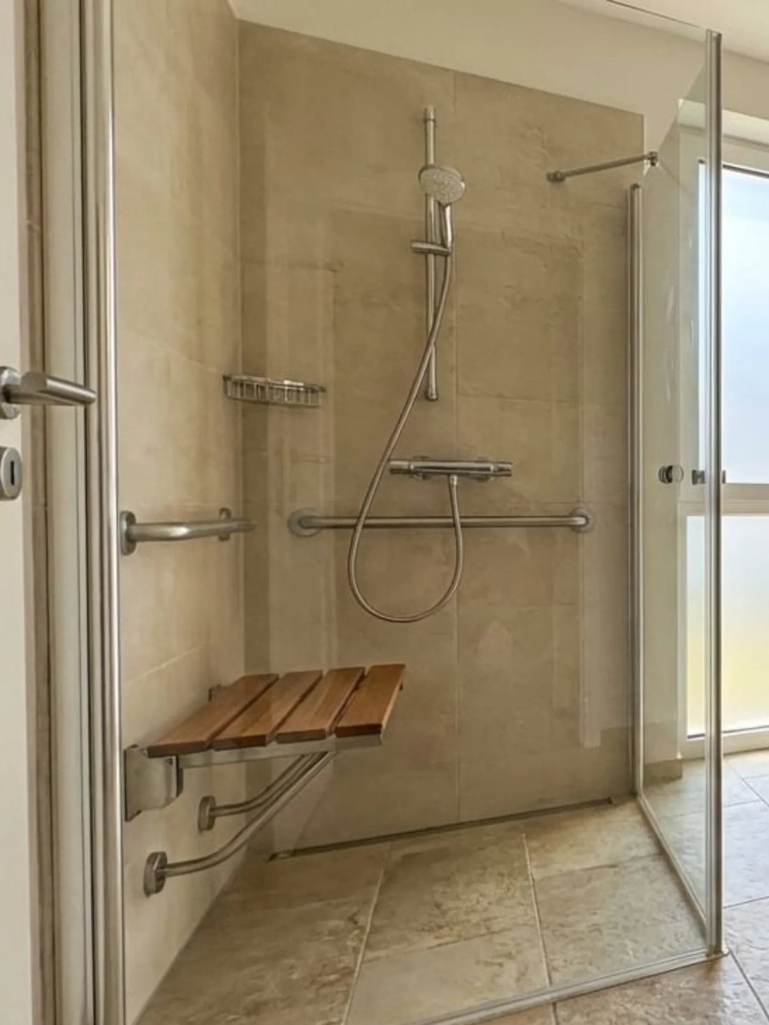 Walk-in accessible shower with grab rails and seat