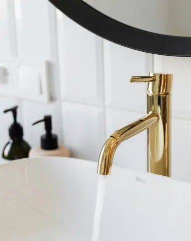 Brass mixer tap fitted over a basin
